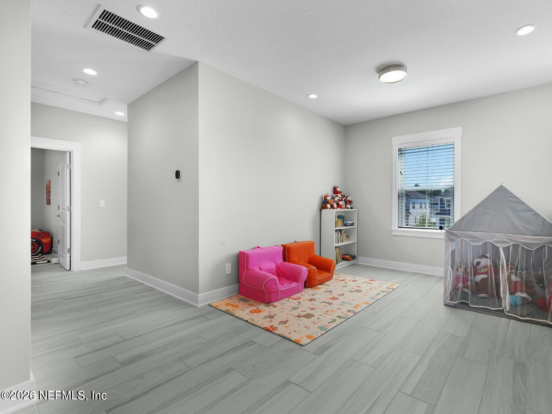 32 Awlleaf Court St. Augustine, FL 32095 - Photo 26 of 40 a bedroom with a bed and wooden floor
