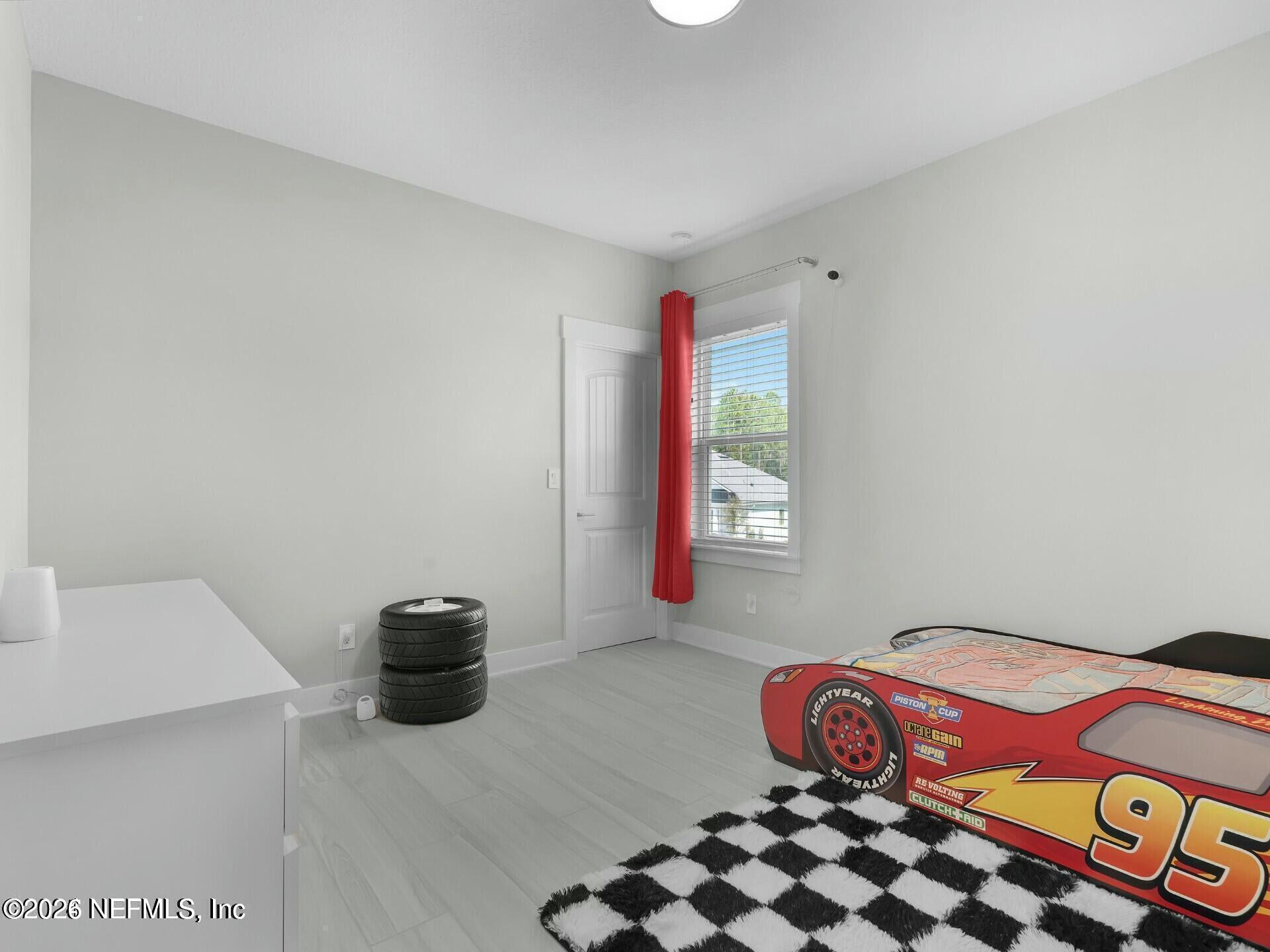 32 Awlleaf Court St. Augustine, FL 32095 - Photo 29 of 40 a bedroom with a bed and a window