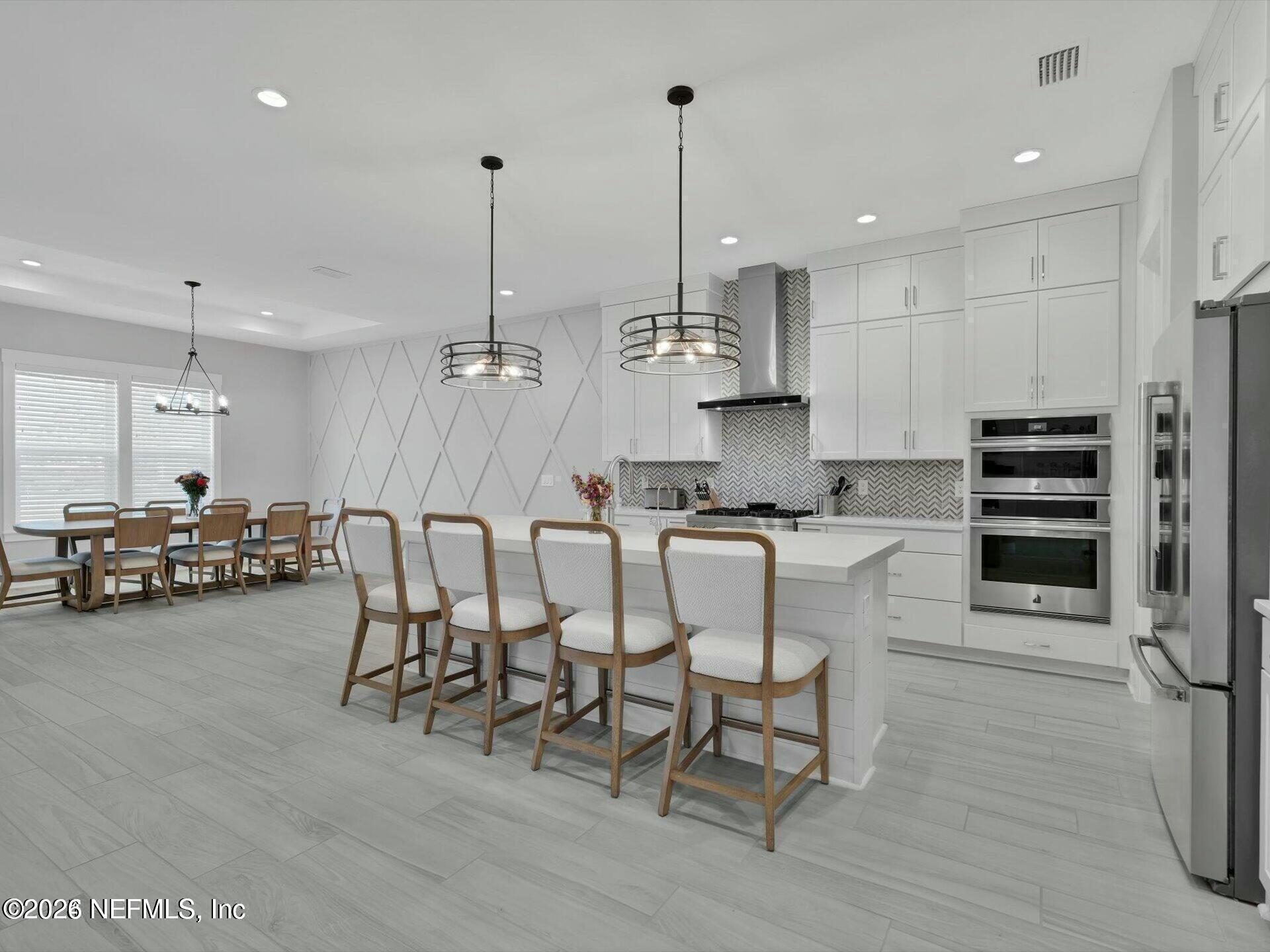 32 Awlleaf Court St. Augustine, FL 32095 - Photo 6 of 40 a large kitchen with a table chairs refrigerator and a sink