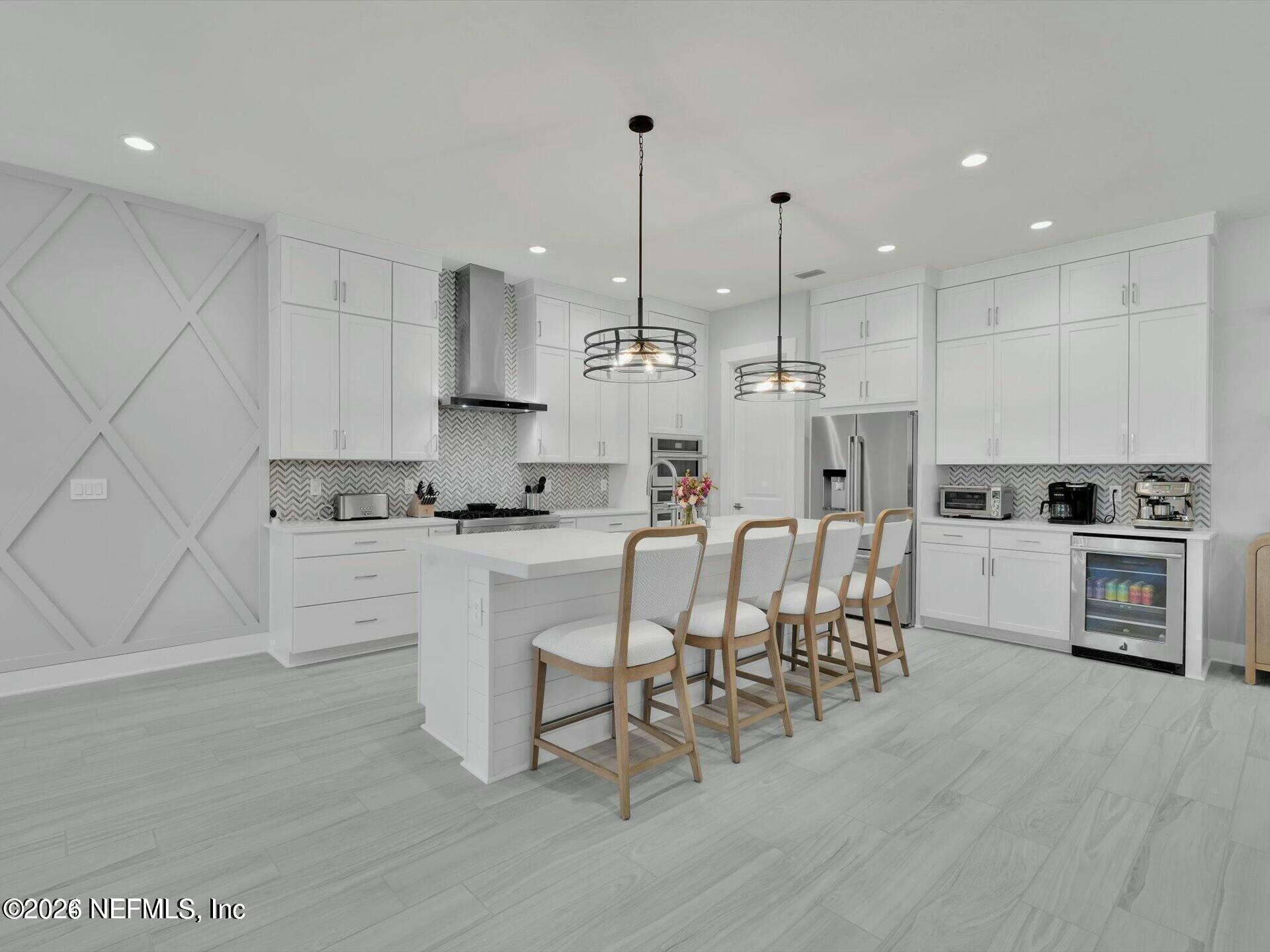 32 Awlleaf Court St. Augustine, FL 32095 - Photo 8 of 40 a kitchen with kitchen island a white counter top space cabinets and stainless steel appliances