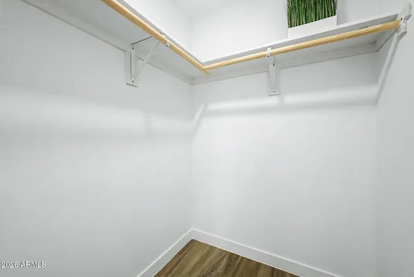 an empty room with a window and ceiling fan