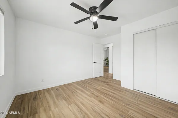 a view of empty room with wooden floor