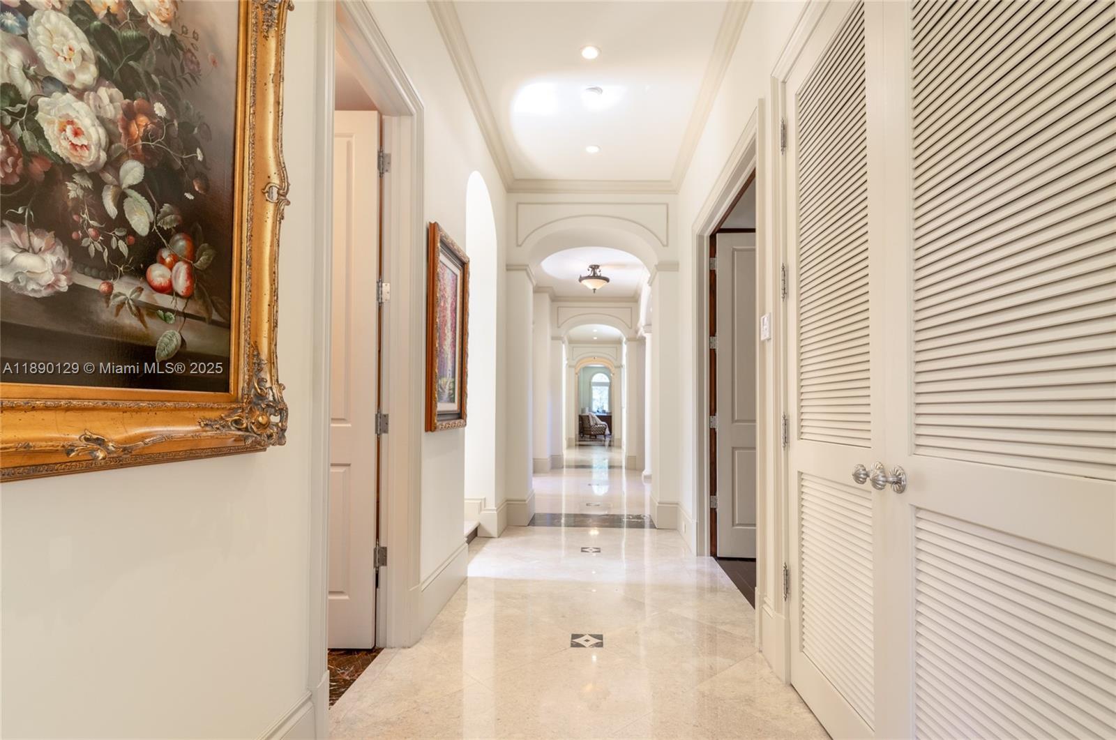 5785 Southwest 96th Street Pinecrest, FL 33156 - Photo 12 of 34 a view of a hallway with wooden floor and a living room