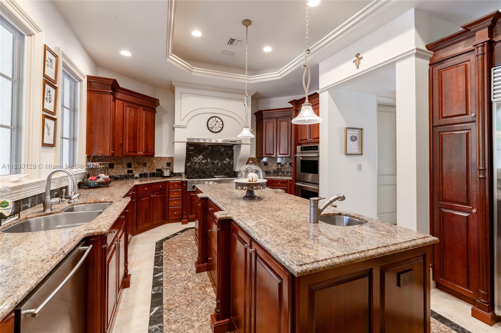 5785 Southwest 96th Street Pinecrest, FL 33156 - Photo 13 of 34 a kitchen with granite countertop kitchen island a table and chairs in it