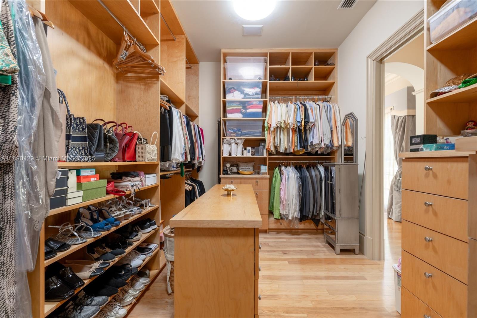 5785 Southwest 96th Street Pinecrest, FL 33156 - Photo 18 of 34 a view of walk in closet with clothes and shoes