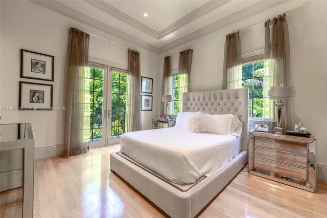 a bedroom with a large bed and a large window