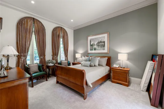 a living room with a bed furniture and a large window