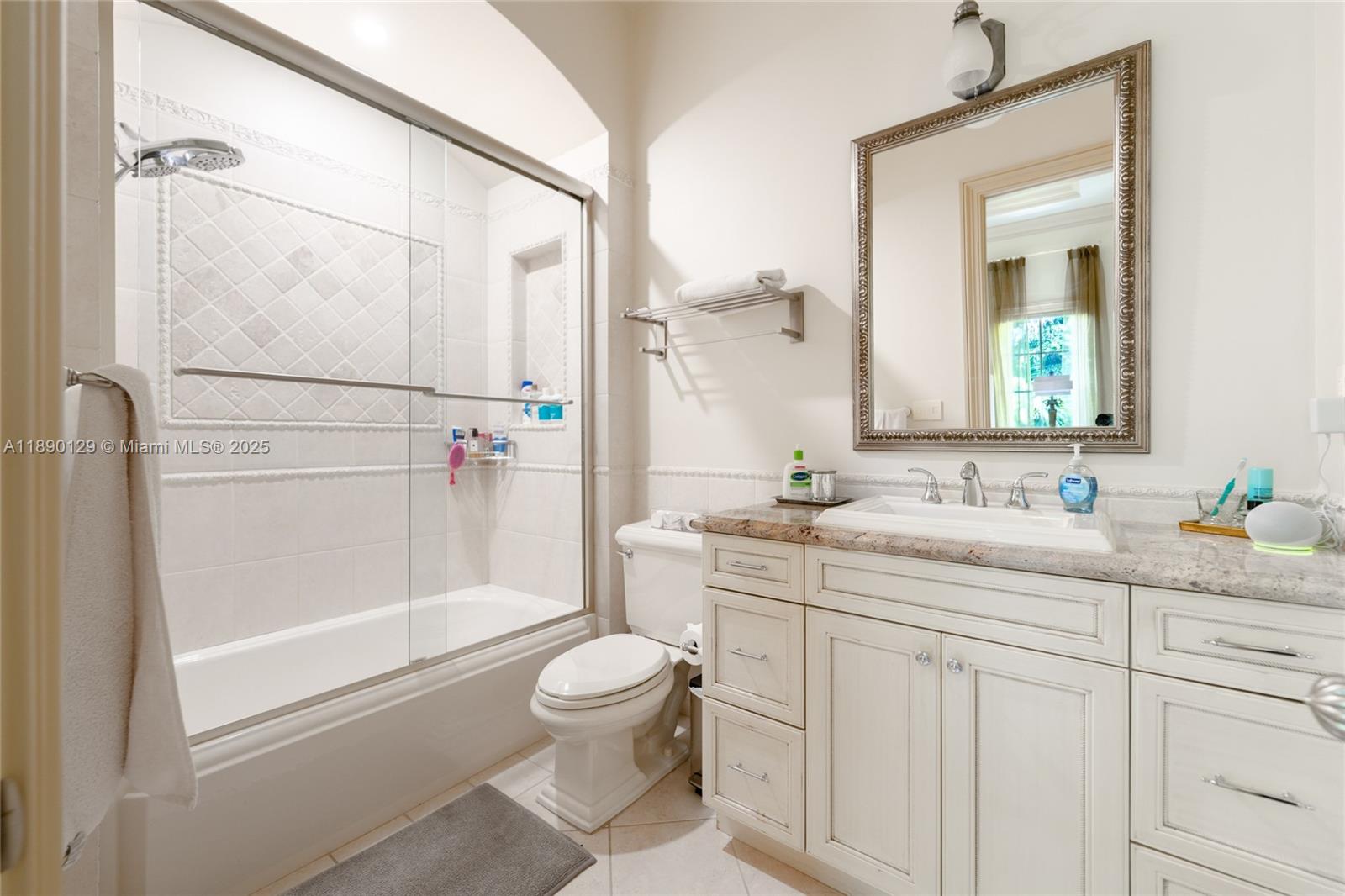 5785 Southwest 96th Street Pinecrest, FL 33156 - Photo 22 of 34 a bathroom with a granite countertop sink toilet and shower