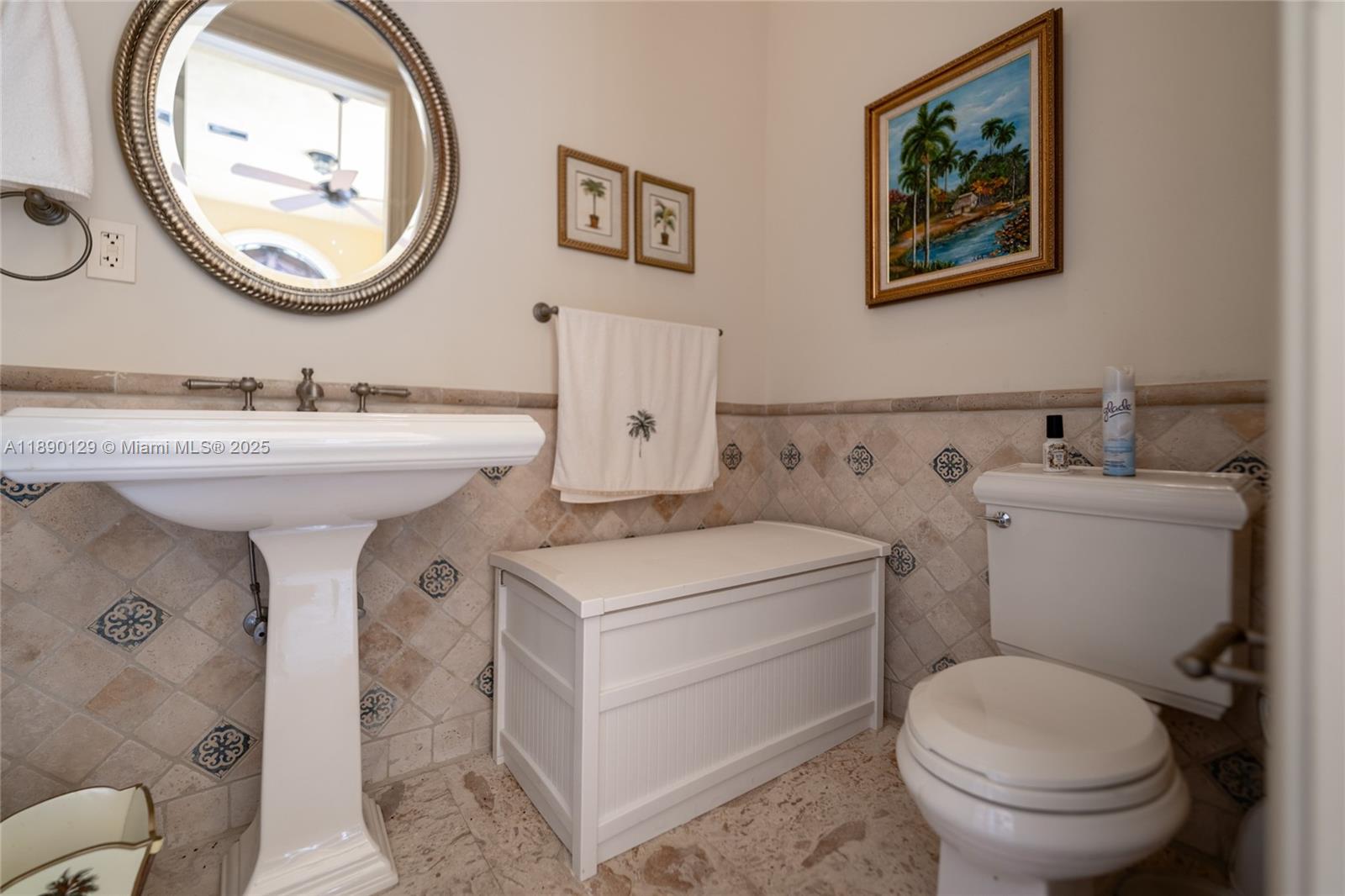 5785 Southwest 96th Street Pinecrest, FL 33156 - Photo 24 of 34 a bathroom with a toilet a sink and a mirror