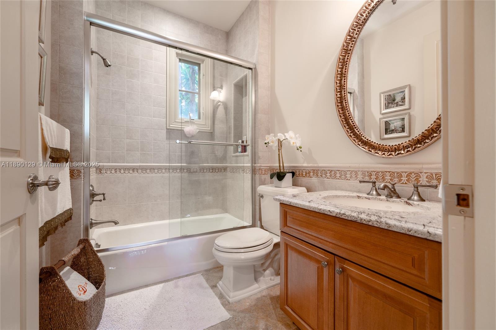 5785 Southwest 96th Street Pinecrest, FL 33156 - Photo 25 of 34 a bathroom with a granite countertop sink mirror vanity and toilet