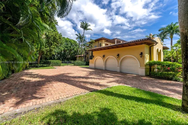 a front view of a house with a garden and yard