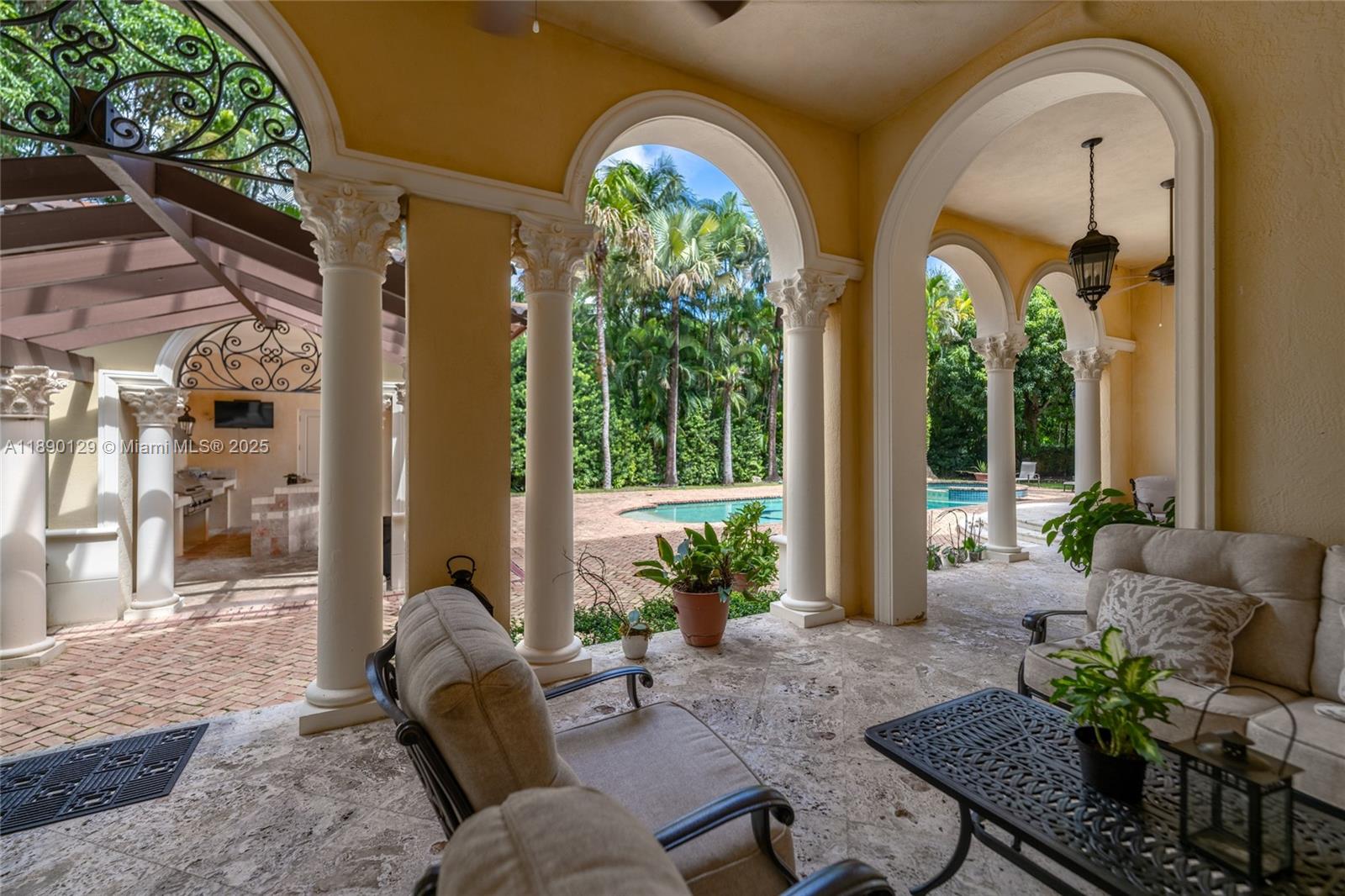 5785 Southwest 96th Street Pinecrest, FL 33156 - Photo 30 of 34 a living room with couches painting on the wall and a potted plant