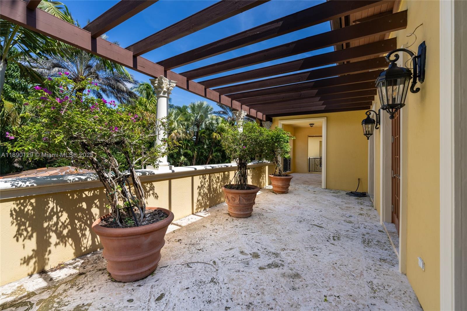 5785 Southwest 96th Street Pinecrest, FL 33156 - Photo 31 of 34 a view of a patio that has plants and potted plants