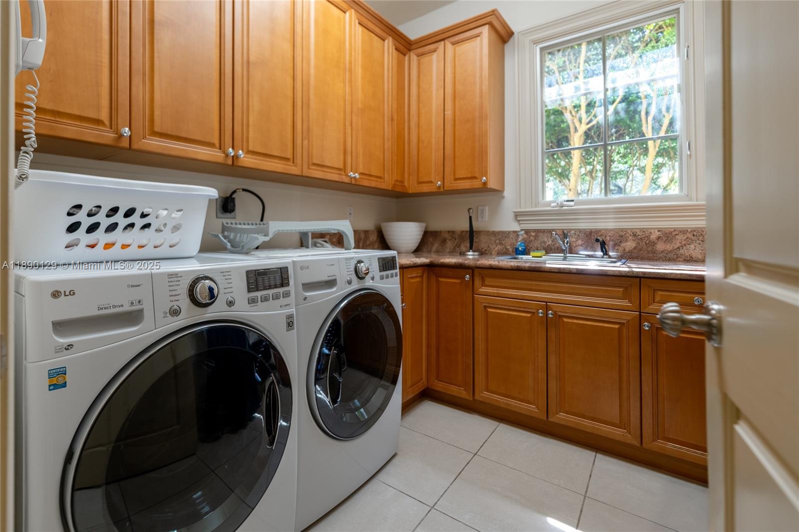 5785 Southwest 96th Street Pinecrest, FL 33156 - Photo 34 of 34 a utility room with sink dryer and washer
