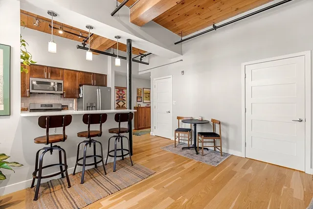a view of a dining room with furniture and wooden floor
