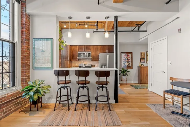 a view of a hallway with wooden floor and stairs
