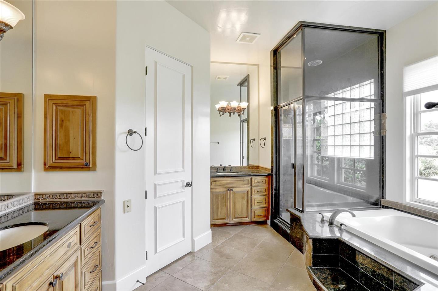 1120 Wallace Road Placerville, CA 95667 - Photo 32 of 70 a spacious bathroom with a granite countertop tub shower and mirror