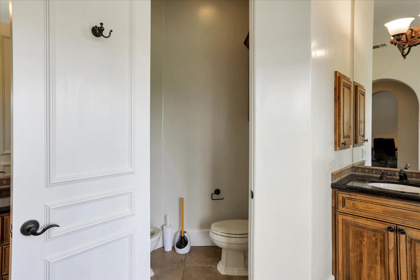 1120 Wallace Road Placerville, CA 95667 - Photo 34 of 70 a bathroom with a toilet sink and a mirror
