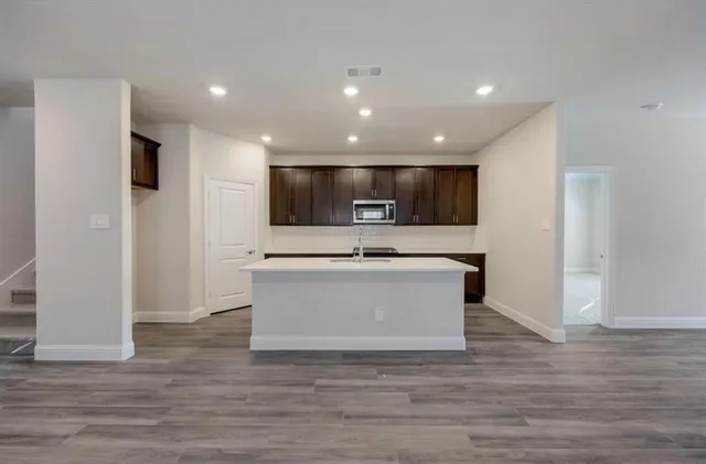 a view of kitchen with stainless steel appliances kitchen island