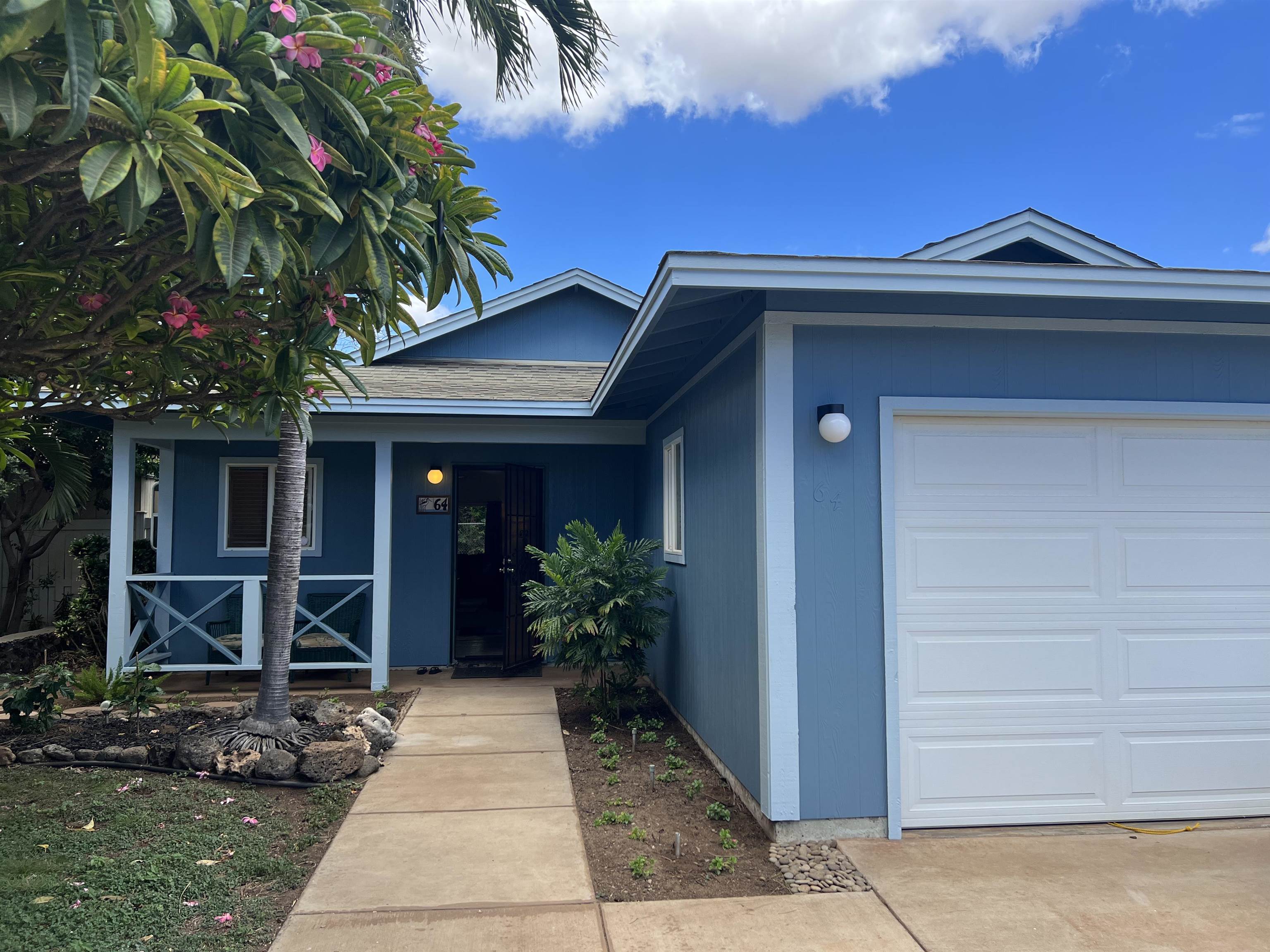 a front view of a house with garden