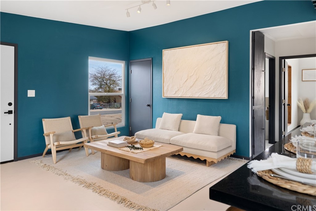 61589 El Reposo Street Joshua Tree, CA 92252 - Photo 2 of 15 a living room with furniture and a window