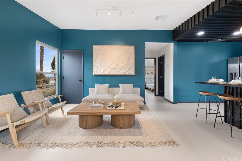 61589 El Reposo Street Joshua Tree, CA 92252 - Photo 3 of 15 a living room with furniture and a flat screen tv