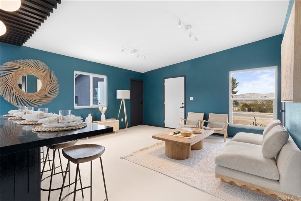 61589 El Reposo Street Joshua Tree, CA 92252 - Photo 4 of 15 a living room with furniture and a large window