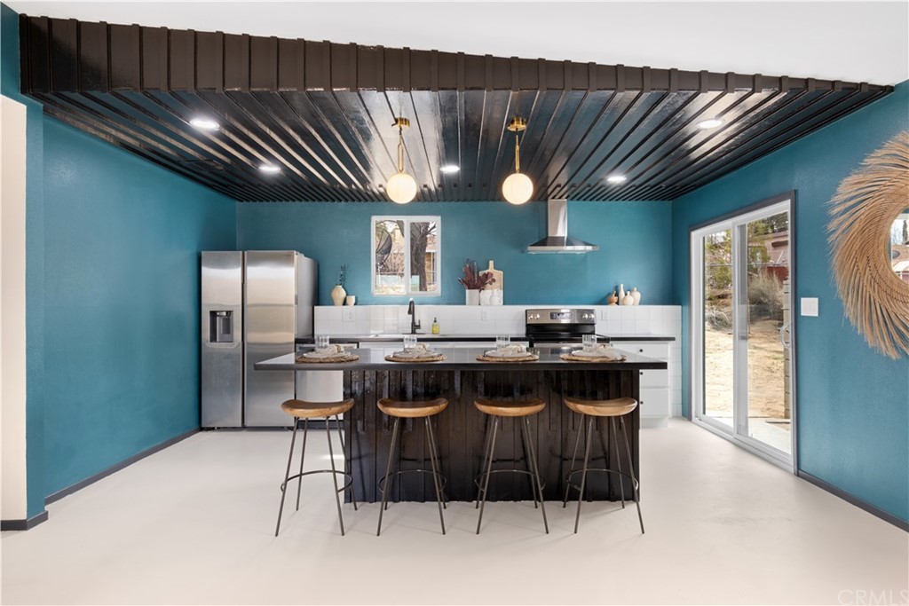 61589 El Reposo Street Joshua Tree, CA 92252 - Photo 5 of 15 a kitchen with a table and chairs