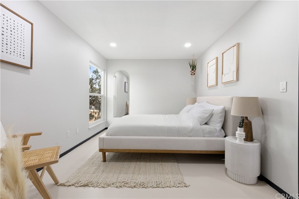 61589 El Reposo Street Joshua Tree, CA 92252 - Photo 10 of 15 a bedroom with a bed and a couch