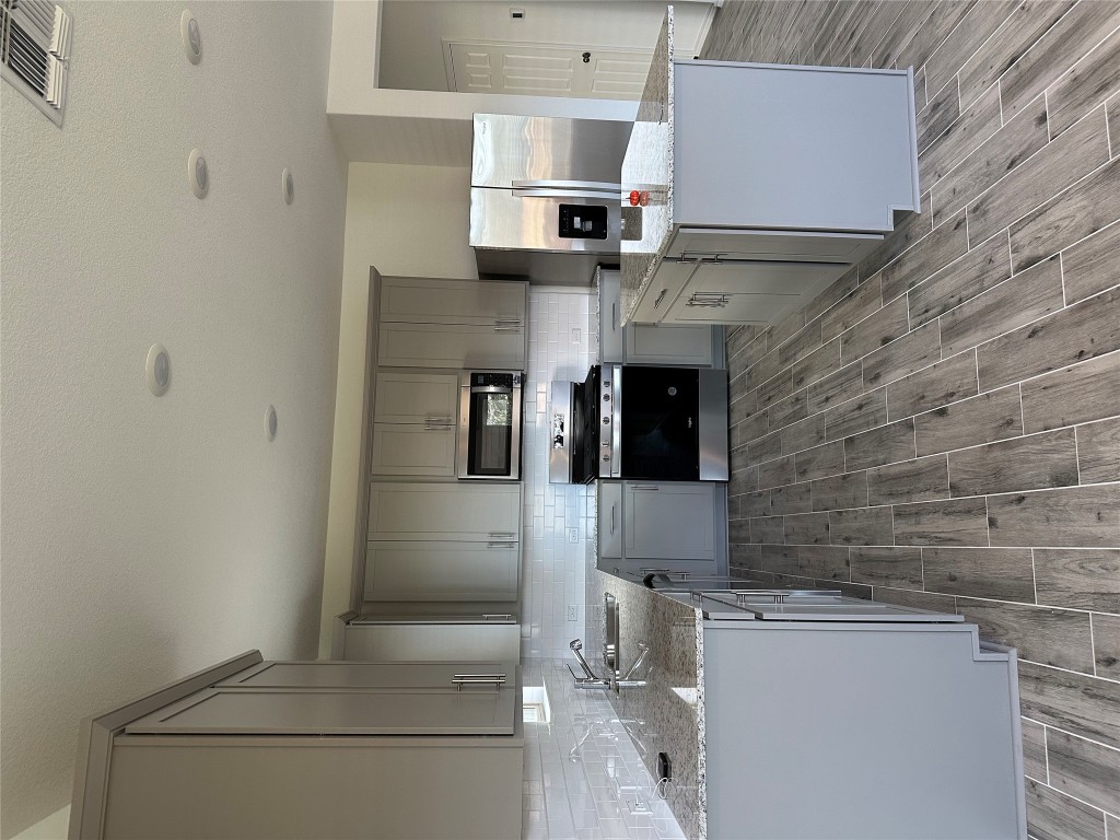 253 Redonda Drive Liberty Hill, TX 78642 - Photo 13 of 18 a kitchen with sink cabinets and stainless steel appliances