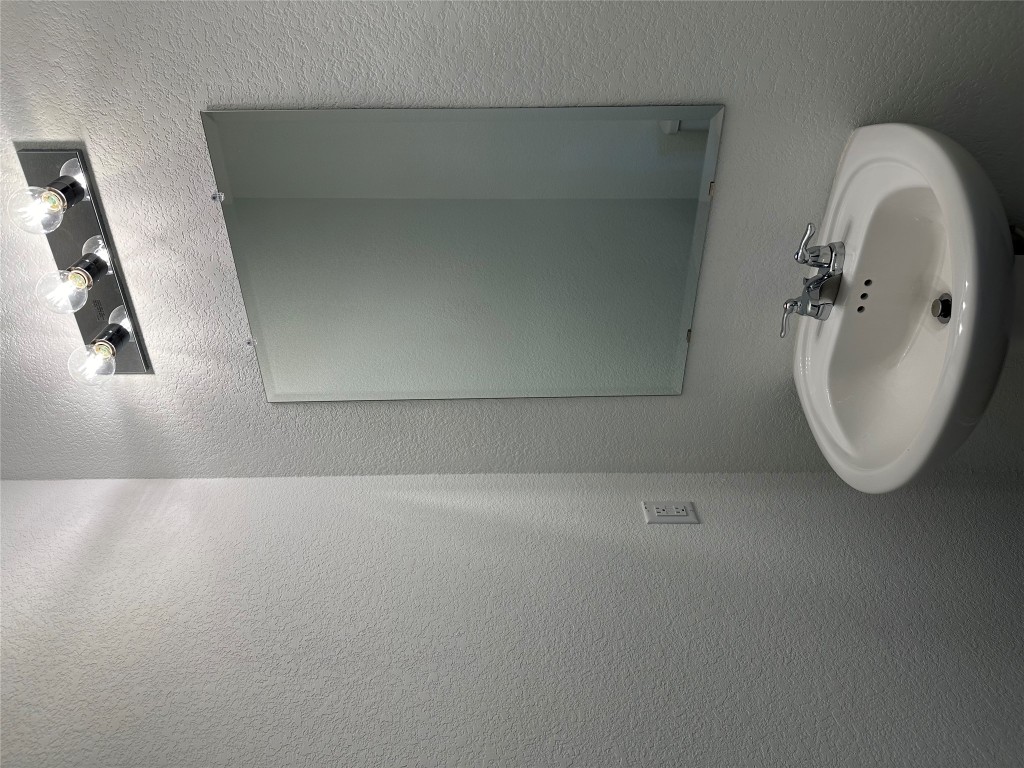 253 Redonda Drive Liberty Hill, TX 78642 - Photo 15 of 18 a bathroom with a sink and a mirror