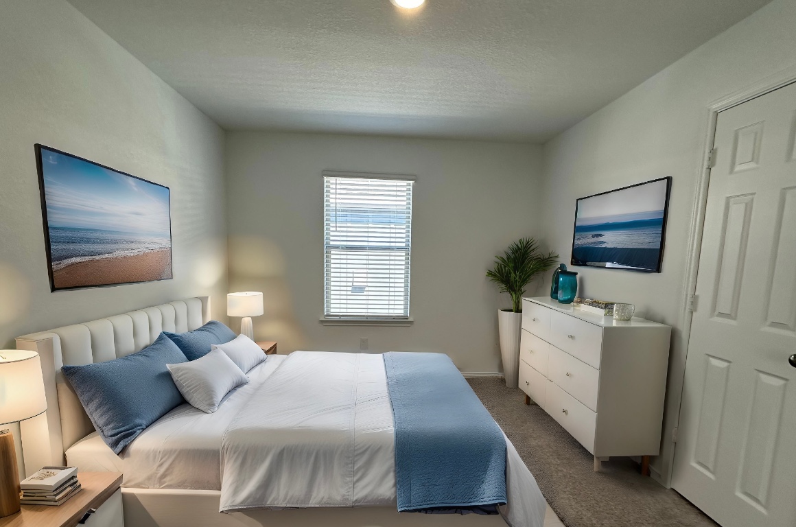 253 Redonda Drive Liberty Hill, TX 78642 - Photo 9 of 18 a bedroom with a bed and flat screen tv