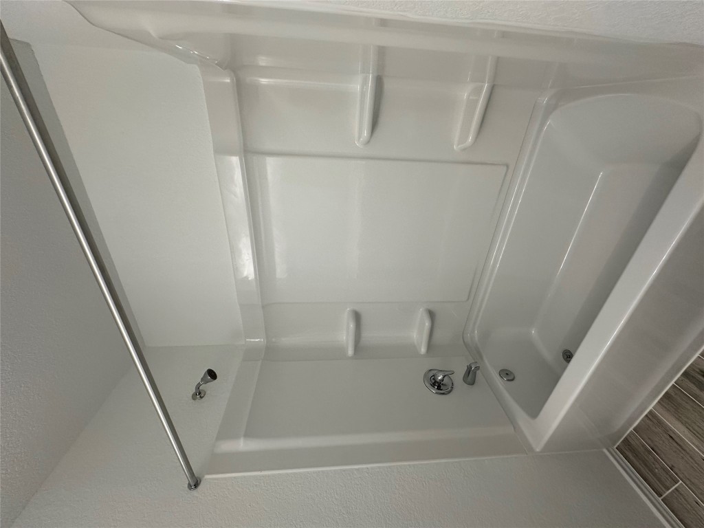 253 Redonda Drive Liberty Hill, TX 78642 - Photo 10 of 18 a bathroom with a bathtub and a shower