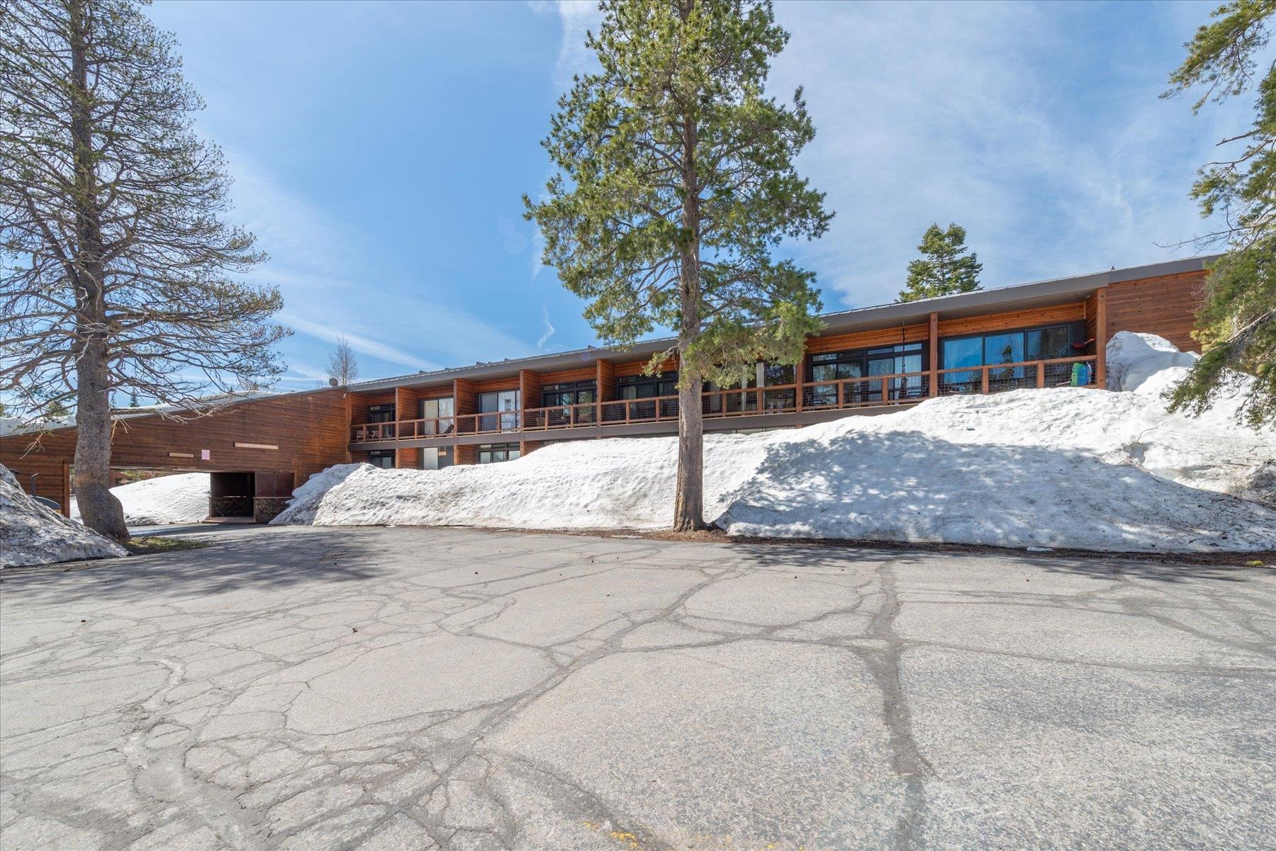 11589 Snowpeak Way, Unit 218 Truckee, CA 96161 - Photo 1 of 20 a white house that has a tree in front of it