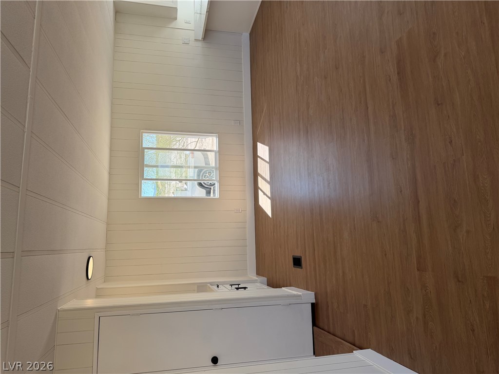6401 Hafen Ranch Road Pahrump, NV 89061 - Photo 5 of 22 Warm wood floors complement clean shiplap walls in this versatile living area.