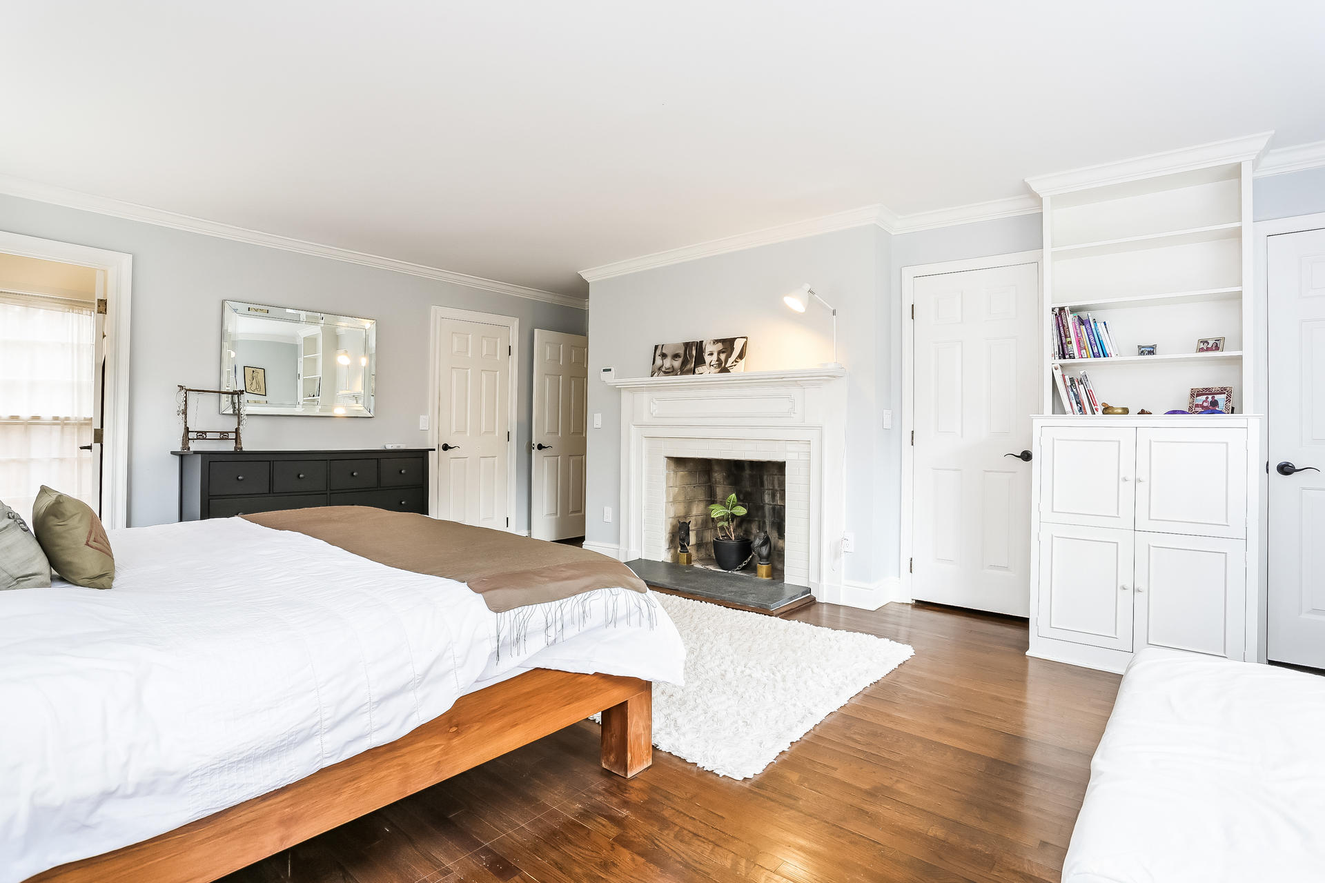 42 Valley Road New Canaan, CT 06840 - Photo 19 of 30 a spacious bedroom with a bed and a fireplace