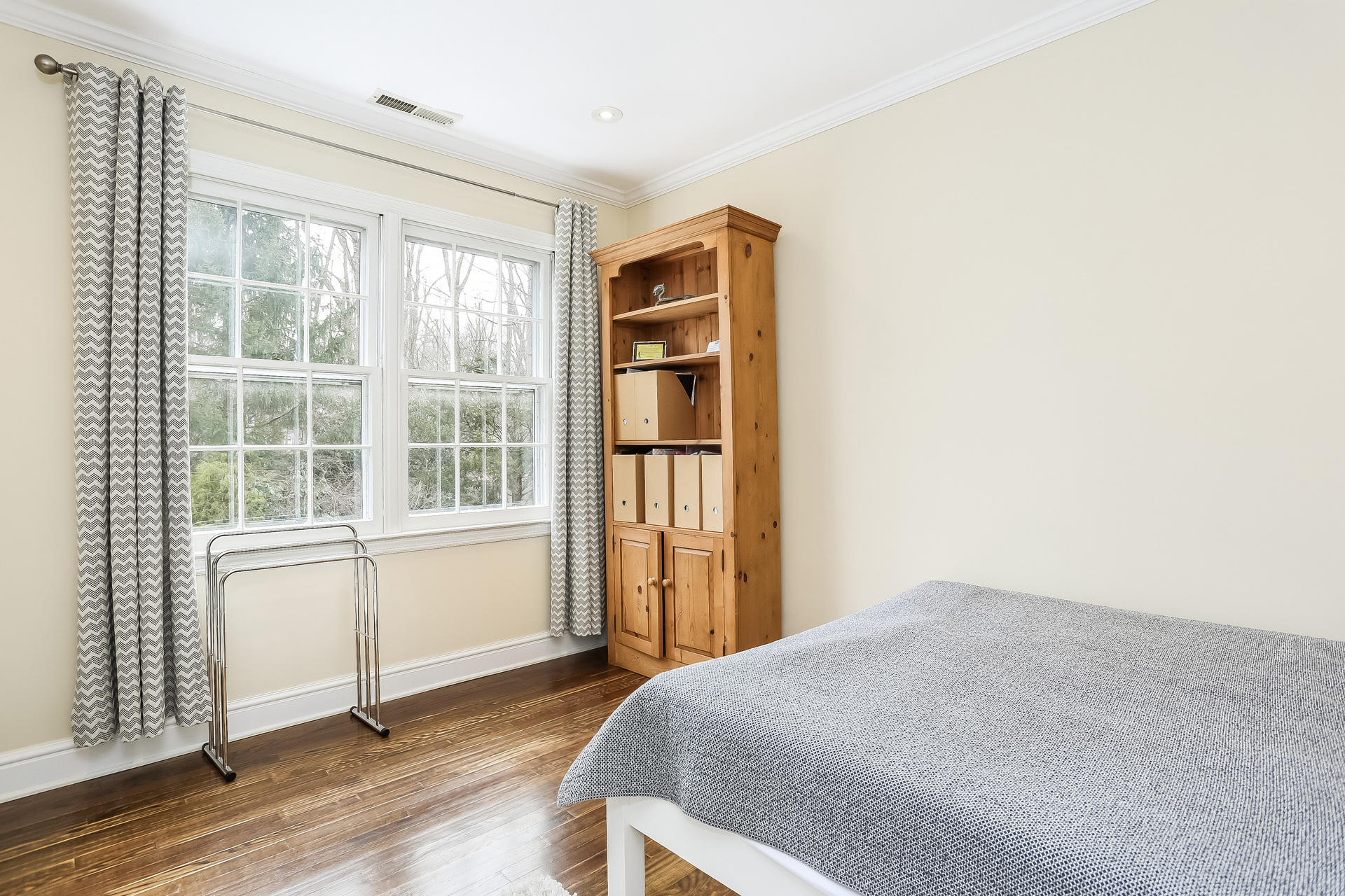 42 Valley Road New Canaan, CT 06840 - Photo 24 of 30 a bedroom with a bed and wooden floor