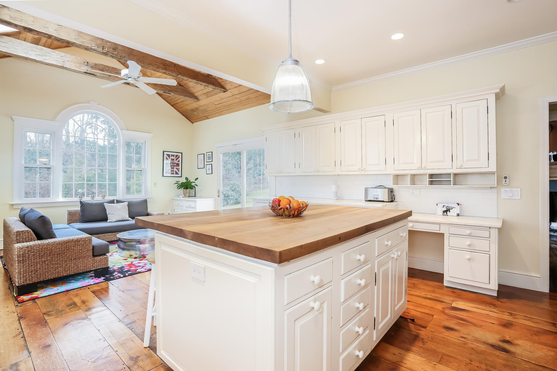 42 Valley Road New Canaan, CT 06840 - Photo 4 of 30 a kitchen with kitchen island a stove a sink a dining table and chairs with wooden floor