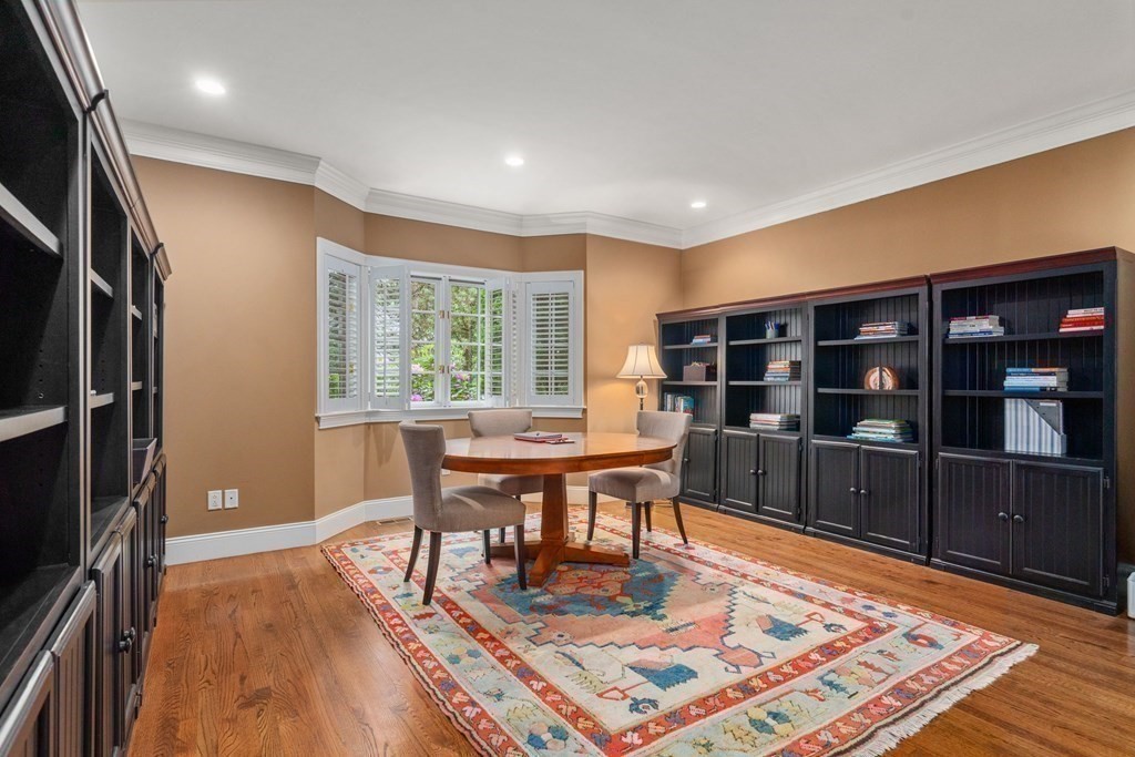 96 Beard Way Needham, MA 02492 - Photo 13 of 39 a living room with furniture a rug and a bookshelf