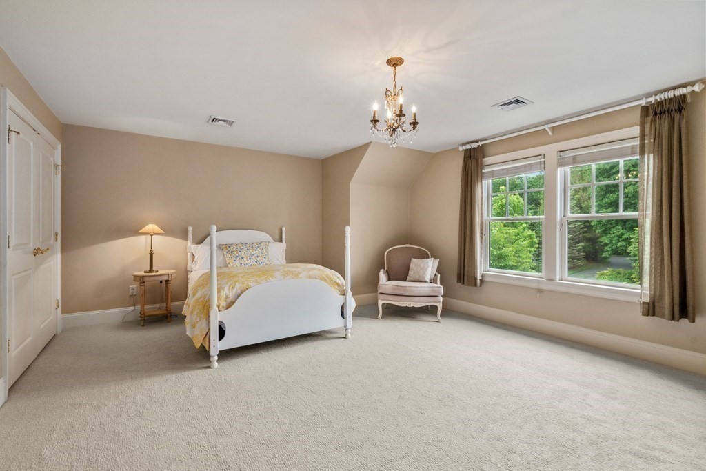 96 Beard Way Needham, MA 02492 - Photo 22 of 39 a spacious bedroom with a bed and a window