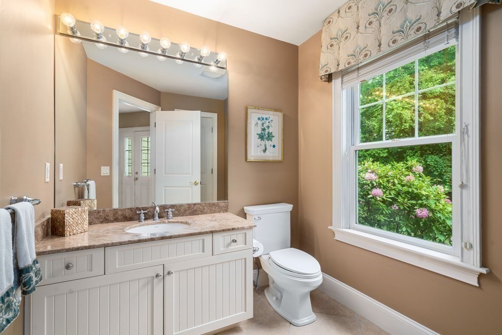 96 Beard Way Needham, MA 02492 - Photo 28 of 39 a bathroom with a granite countertop sink mirror vanity and a toilet