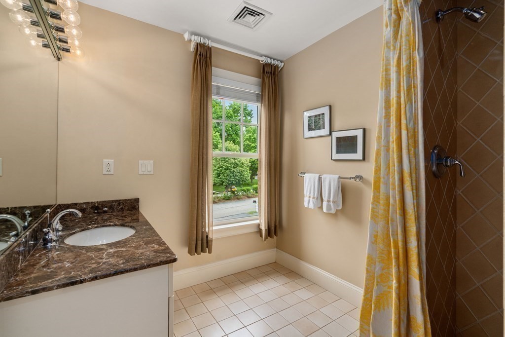 96 Beard Way Needham, MA 02492 - Photo 29 of 39 a bathroom with a sink a mirror and a shower