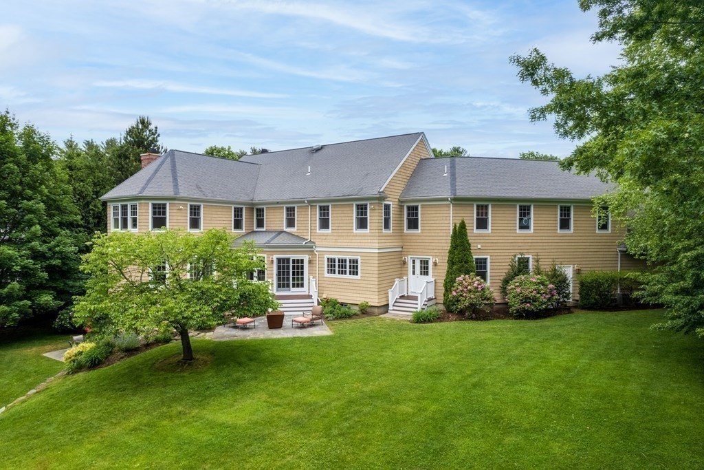 96 Beard Way Needham, MA 02492 - Photo 33 of 39 a front view of a house with a garden and plants
