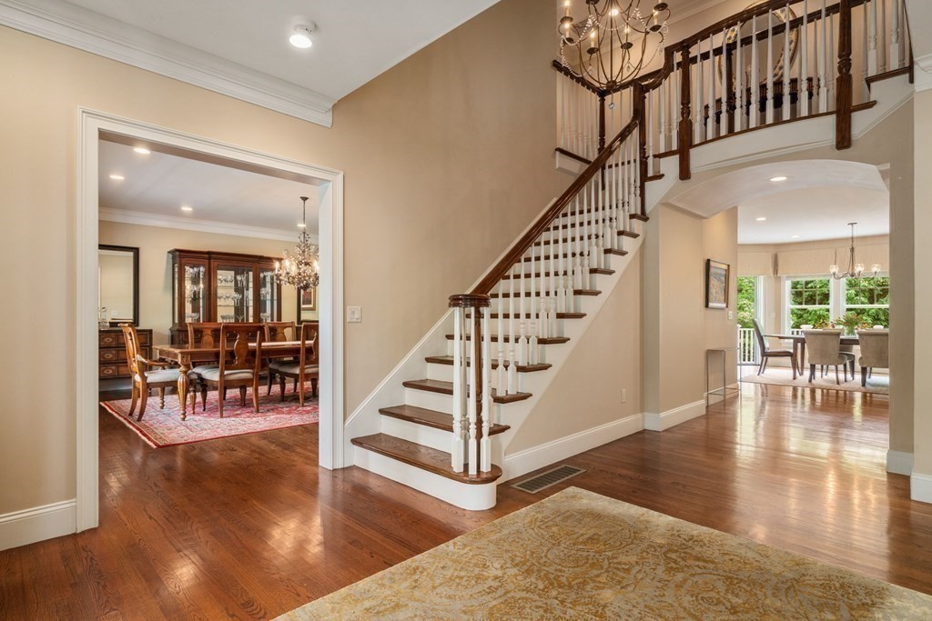 96 Beard Way Needham, MA 02492 - Photo 5 of 39 a view of staircase with dining table and wooden floor