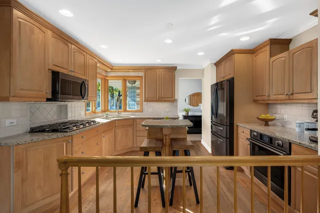 a kitchen with stainless steel appliances granite countertop a refrigerator a stove top oven a sink and dishwasher