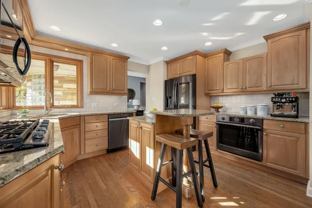 a kitchen with a stove a sink a microwave and cabinets