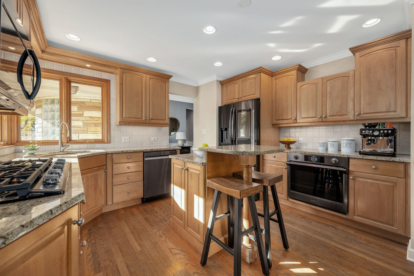 5305 Howard Avenue Western Springs, IL 60558 - Photo 12 of 35 a kitchen with a stove a sink a microwave and cabinets
