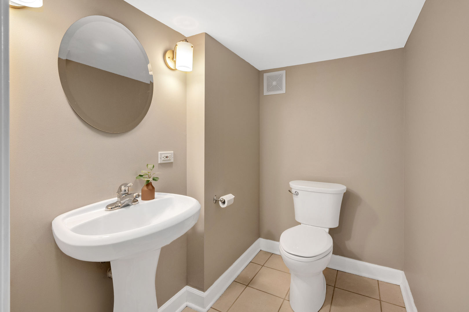 5305 Howard Avenue Western Springs, IL 60558 - Photo 26 of 35 a bathroom with a toilet a sink and mirror