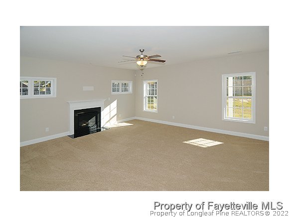 158 Shellbark Drive Spring Lake, NC 28390 - Photo 4 of 15 a living room with a fireplace furniture a chandelier and a window