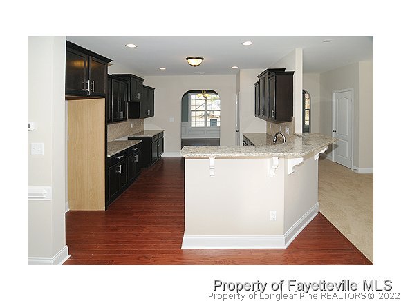 158 Shellbark Drive Spring Lake, NC 28390 - Photo 6 of 15 a living room with stainless steel appliances kitchen island granite countertop furniture and a view of kitchen